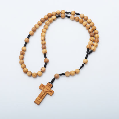 Wooden rosary with a cross on a white background