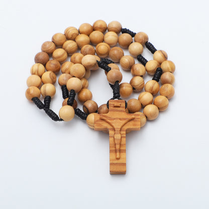 Wooden rosary with black rope accents on a white background