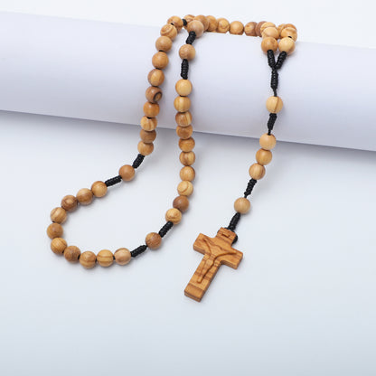 Wooden rosary with a cross on a white background