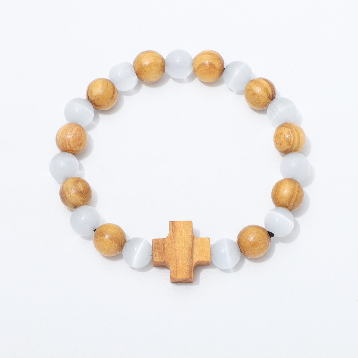 A beaded stretch bracelet featuring alternating light brown wooden beads and translucent white cat's eye beads, finished with a central wooden cross charm, shown on a plain white background.