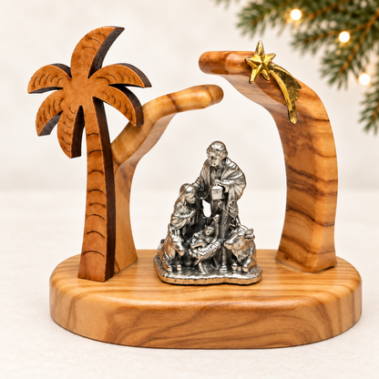 Olive wood nativity handmade in Bethlehem, with the Holy Family, palm tree and golden star in a Christmas setting.
