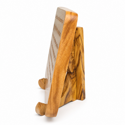 Side profile of the olive wood scripture plaque showing its rounded edge, thickness and wooden display stand.