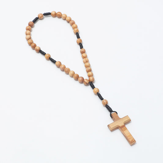 Olive wood 6mm prayer beads arranged in a long loop with cross, viewed at an angle