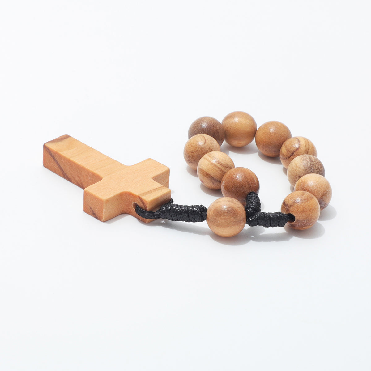 Round 10mm olive wood beads and black cord knots beside a plain cross, viewed from the side