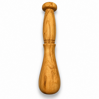Matching olive wood pestle with a rounded grinding end, shaped handle and decorative carved rings.