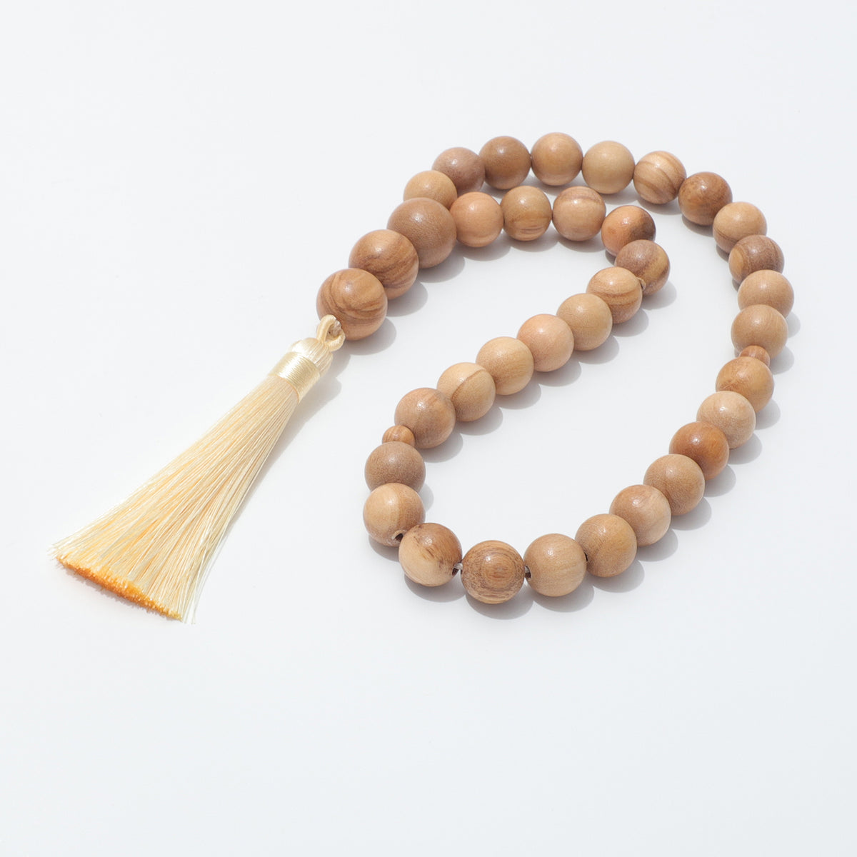 Close view of 12 mm olive wood prayer beads and their natural grain