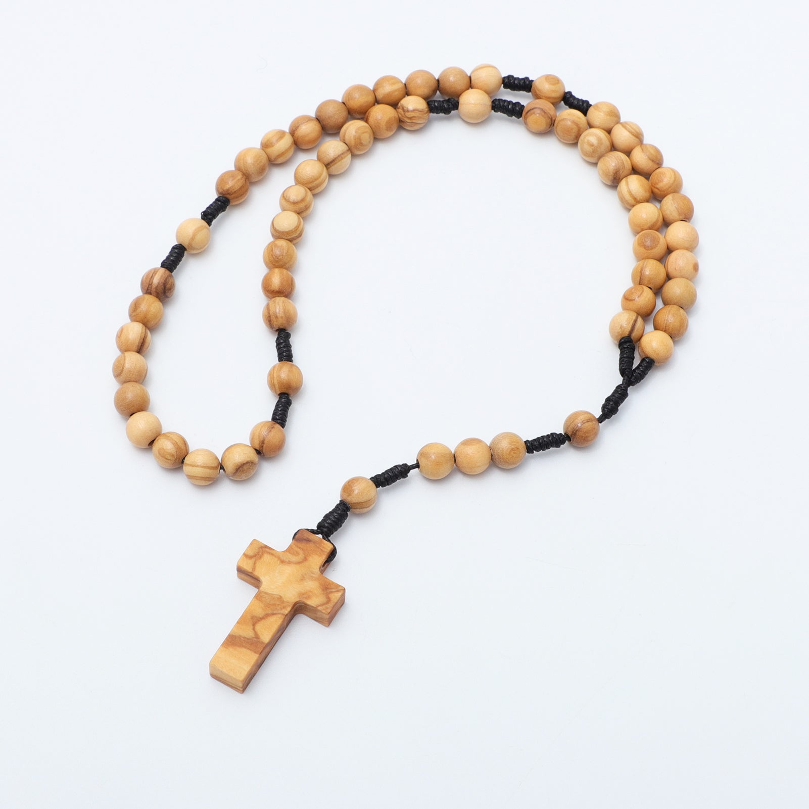 Wooden rosary with a cross on a white background