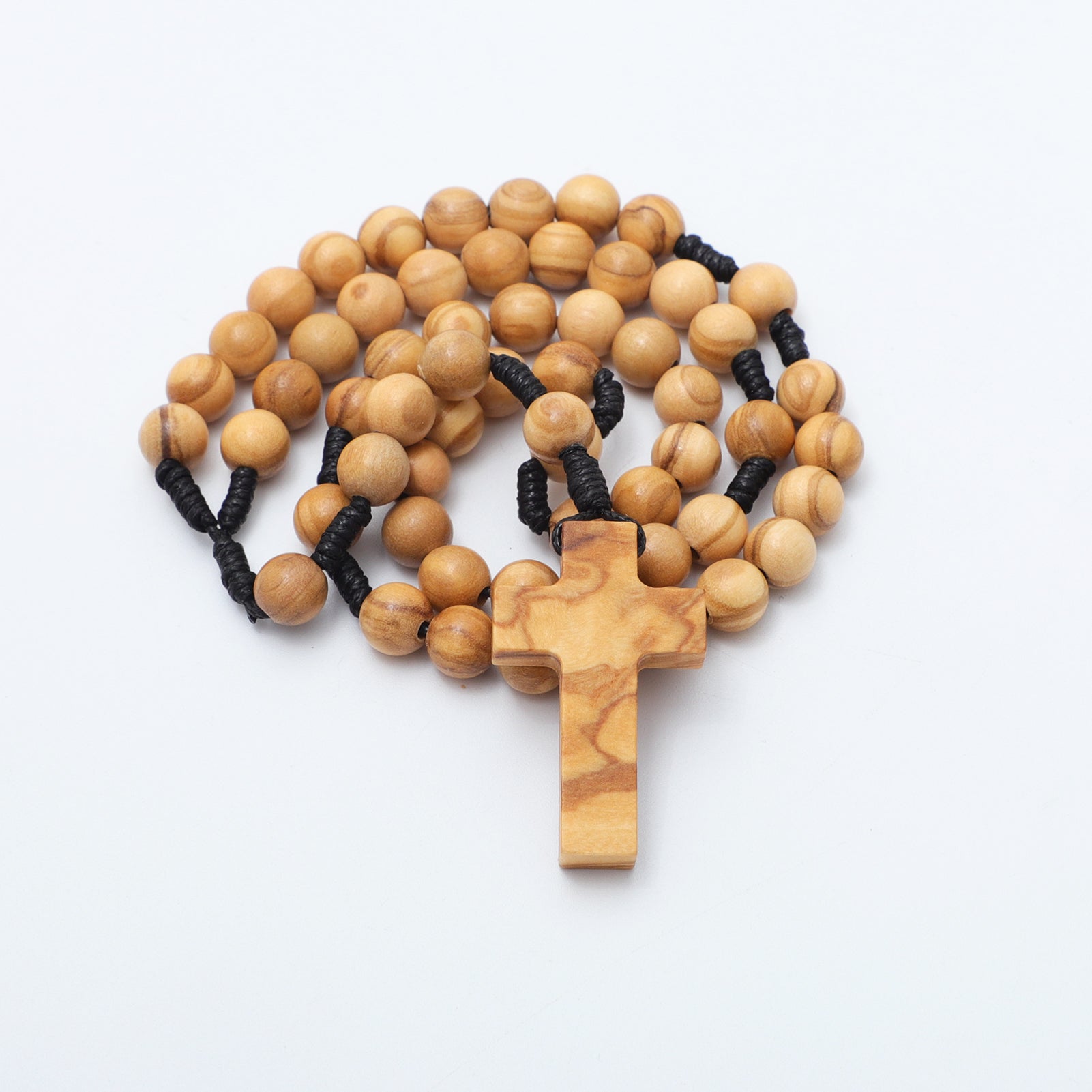Wooden rosary with black rope on a white background