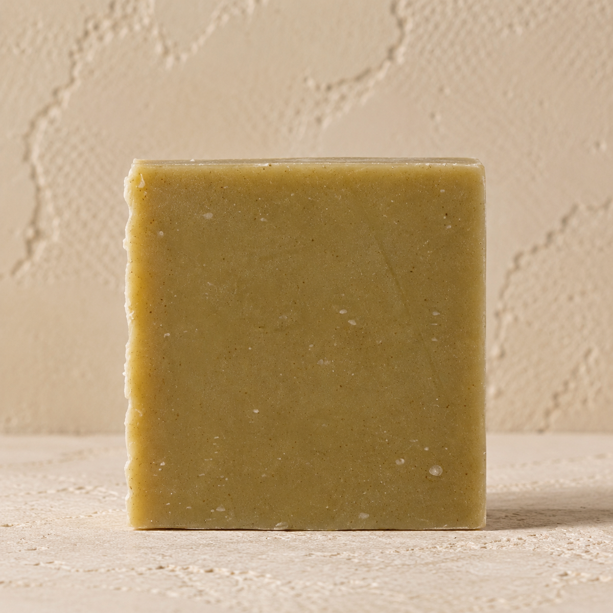 Rhassoul clay soap bar handmade in Nazareth on a warm textured background