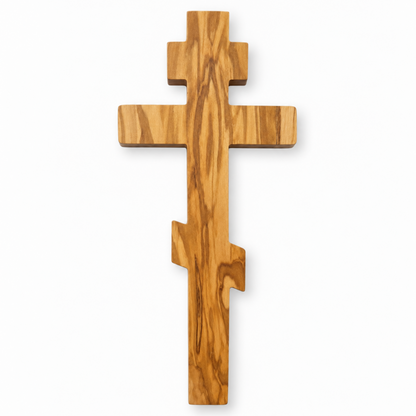 Front view of a Russian Orthodox olive wood wall cross handcrafted in Nazareth, with three crossbars and flowing wood grain.