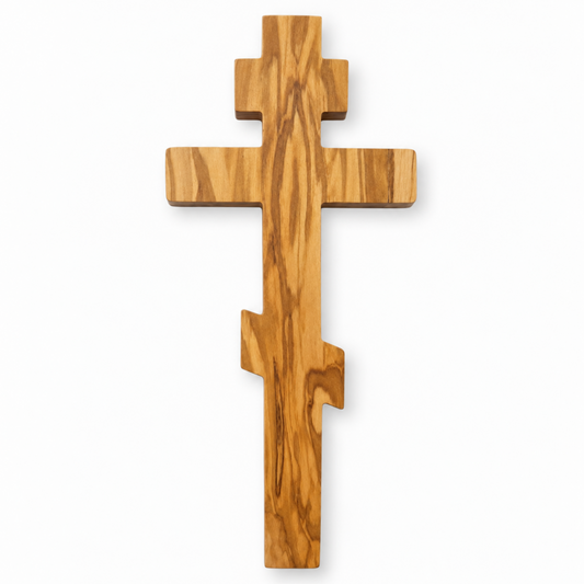 Front view of a Russian Orthodox olive wood wall cross handcrafted in Nazareth, with three crossbars and flowing wood grain.